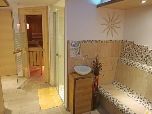 a bathroom with a sink and a shower at Apartment Alpenhof-1 by Interhome in Sinsen