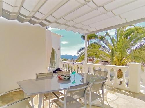 a white dining room with a table and chairs at Holiday Home Colombia 16 by Interhome in L’Alfàs del Pi