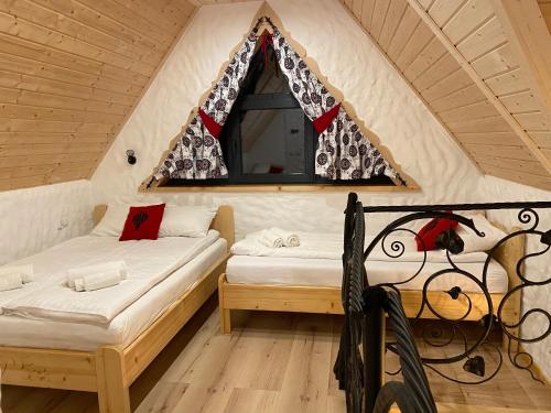 a bedroom with two beds in a tent at Domek Góralski Nad Potokiem in Witów