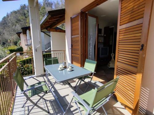 a table and chairs on the balcony of a house at Apartment La Rocca by Interhome in Castelveccana
