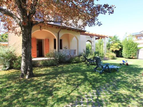 a house with a tree and a bench in the yard at Villa Villa Gino by Interhome in Forte dei Marmi