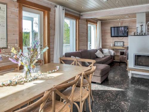 a living room with a wooden table and a couch at Holiday Home Saaruan aurinko by Interhome in Ruka