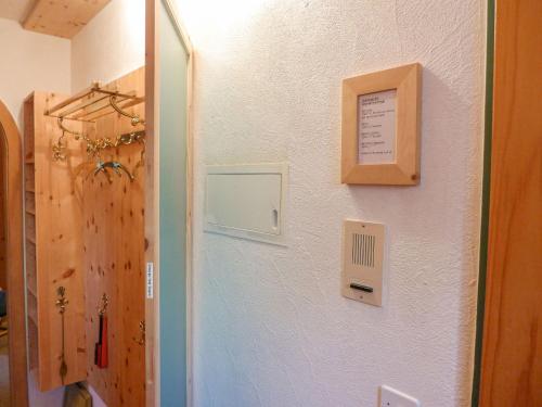 a hallway with a door and a wall with a sign at Apartment Chesa Alvetern 5 by Interhome in Sils Maria