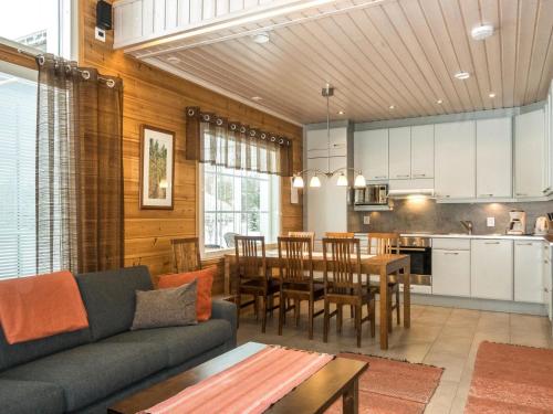 a living room and kitchen with a couch and a table at Holiday Home Pyrykieppi by Interhome in Sonka