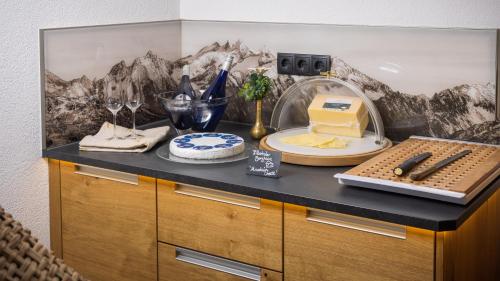 a table with a cake and a piece of cheese at Der Siegeler B&B - this lifestylehotel rocks in Mayrhofen