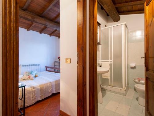 a bedroom with a bed and a sink and a toilet at Holiday Home Paradiso II by Interhome in Bolognana