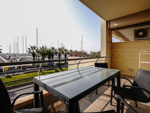 a table on a balcony with a view of a highway at Apartment Marta by Interhome in Terzorio