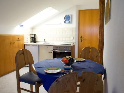 a kitchen with a table with a blue table cloth on it at Apartment Fischer by Interhome in Lechbruck
