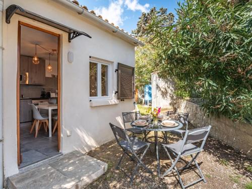 a patio with a table and chairs in front of a house at Holiday Home Sepia by Interhome in Sari Solenzara