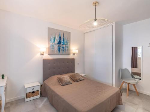 a bedroom with a bed and a desk and a chair at Holiday Home Polpu by Interhome in Sari Solenzara