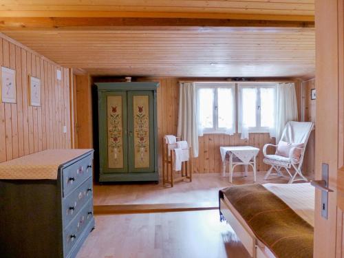 a room with a bed and a table and chairs at Holiday Home Chalet Esther by Interhome in Brienz