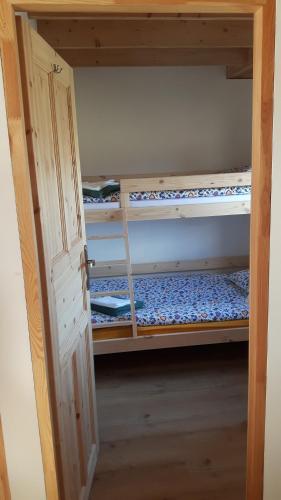 an open door to a room with a bunk bed at Małe Kaszuby in Słajszewo