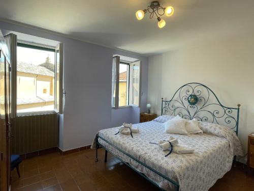 a bedroom with a bed with two shoes on it at Holiday Home Arietta VLO150 by Interhome in Valloria