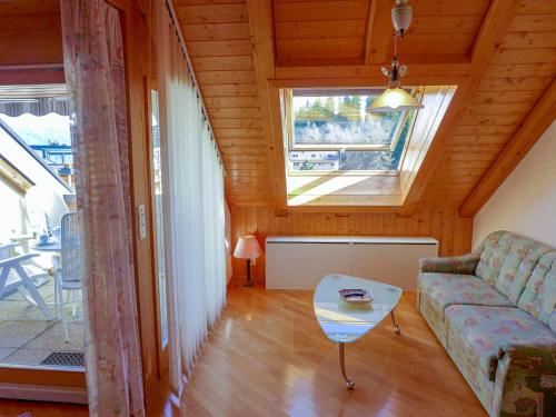 a living room with a couch and a table at Apartment les Vignettes by Interhome in Crans-Montana