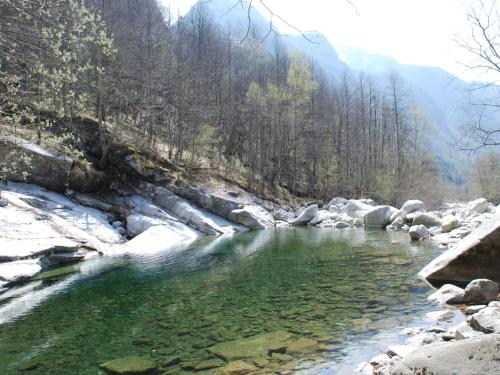 a river with snow on the sides of it at Holiday Home Signorile by Interhome in Peccia