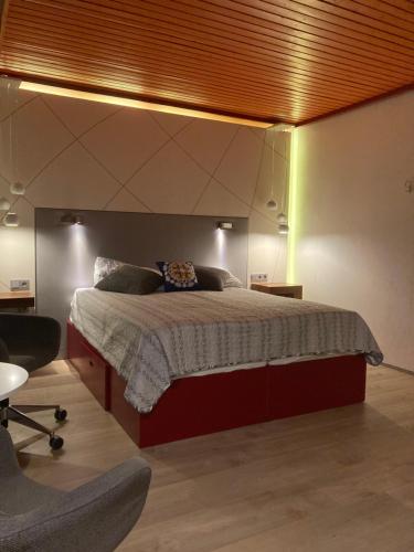 a bedroom with a large bed with a wooden ceiling at Paatsalu Sadam in Paatsalu