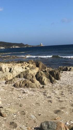 a rocky beach with the ocean in the background at Beni Benìus in Teulada