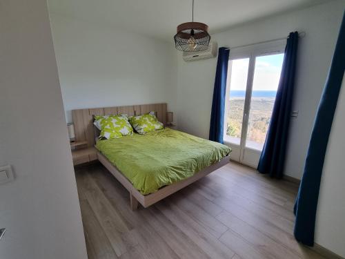 a bedroom with a bed and a large window at Casa Di Vadella in Santʼ Andrea-di-Cotone