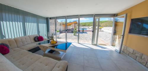 a living room with a couch and a table at Villa Plavota in Ljubuški