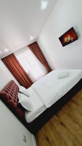 a bedroom with a large bed with a window at ЖК МАДИНА ЕВРА ДВУШКА in Kokshetau