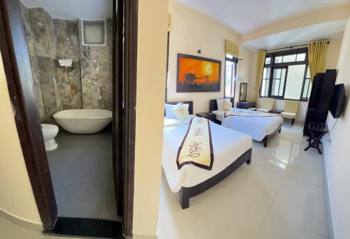 um quarto de hotel com uma cama e uma casa de banho em Hoi An Cottage Villa em Hoi An