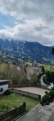 a view of a river and mountains from a house at Pension – Restaurant Jägerwinkl in Rettenberg