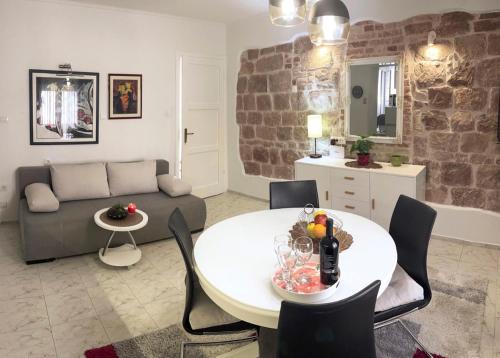 a living room with a couch and a table at Apartment Vitturina in Kaštela