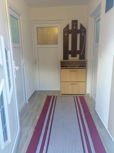 a hallway with a door and a rug at Villa Dino in Kulen Vakuf