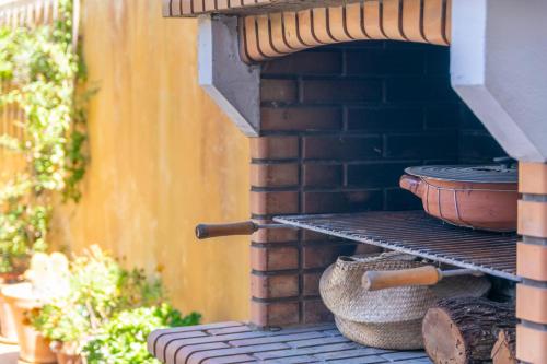 a brick oven with a pot on a rack at Els Àngels in Ses Salines