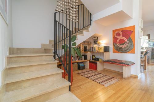 a living room with a staircase in a house at Els Àngels in Ses Salines