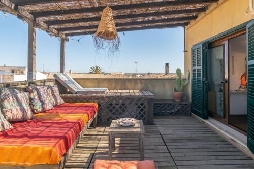a patio with a couch and a table at Els Àngels in Ses Salines