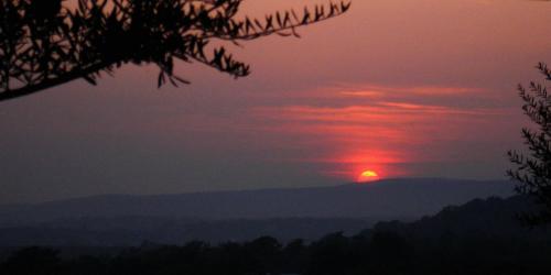 a sunset with the sun in the sky at L'Isola Di Rosa - Relais & Hotel di Charme in Cerveteri