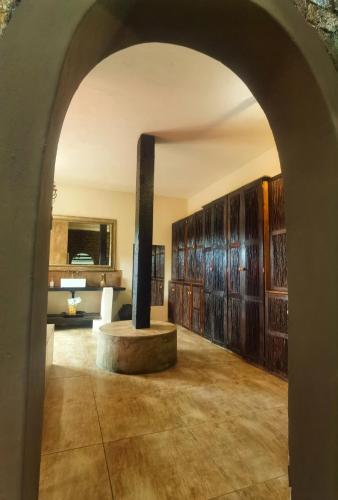 an archway leading into a room with wooden cabinets at Camelot Guesthouse in Newcastle