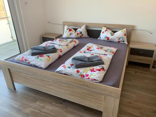 a bed with pillows on it in a room at 4 * Wohnung SPA Whirlpool & Sauna in Seenähe in Ramsberg