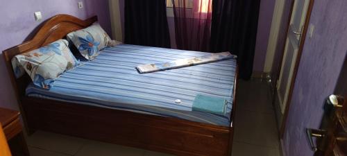 a bed with a clarinet laying on top of it at HOTEL-LE-PARISIEN in Brazzaville
