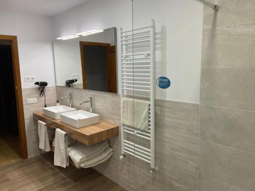 a bathroom with a sink and a mirror at Casa Solatillo in Ayerbe