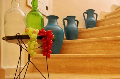 a bunch of vases and a bunch of grapes at Necdet Kaptan Bozcaada in Bozcaada