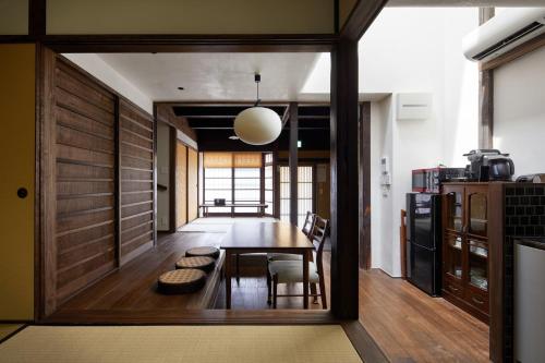 a dining room with a table and some chairs at Tachibana an in Kyoto