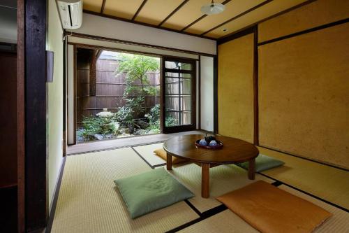 a room with a table and a large window at Tachibana an in Kyoto