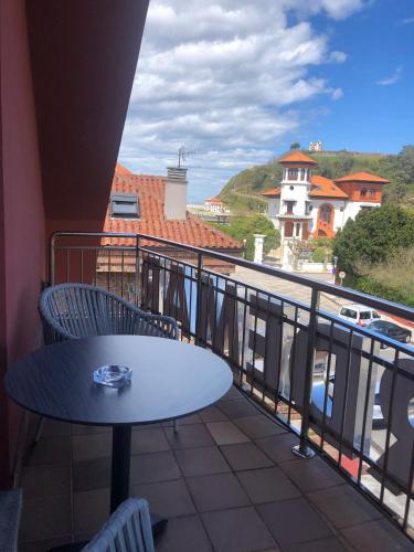 a table and chairs on a balcony with a view at Hotel Verdemar in Ribadesella
