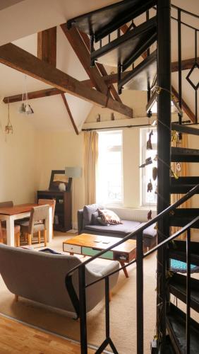 a living room with a loft bed and a couch at Ebrington Street View in Plymouth