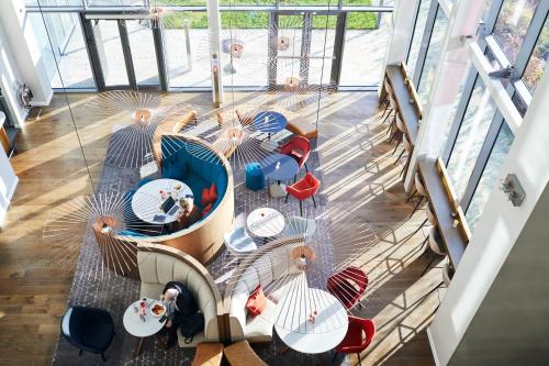 an overhead view of a table with chairs and umbrellas at Hyatt House Manchester - Aparthotel in Manchester
