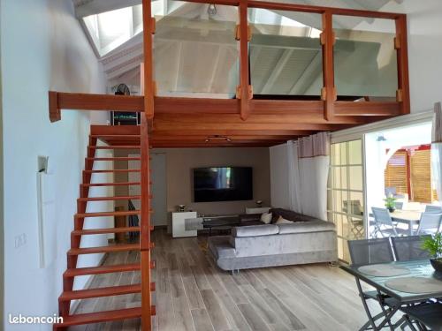 a loft bed in a living room with a couch at Villa de 4 chambres avec vue sur la mer piscine privee et jacuzzi a Le Marin a 3 km de la plage in Le Marin
