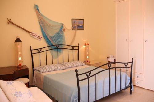 a bedroom with a bed with a blue net at La Cascata in Noci