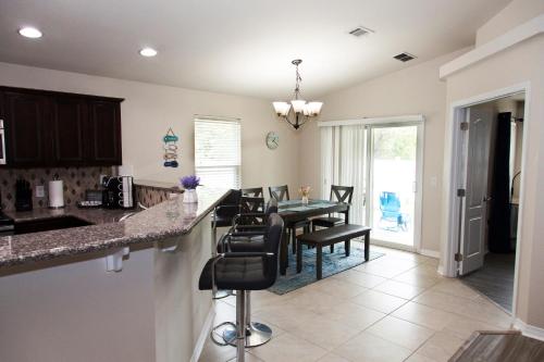 a kitchen and dining room with a table and chairs at Beachy Bliss the perfect stay in Navarre