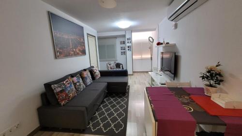a living room with a couch and a table at APARTAMENTS B O D CoLLBLANC in Hospitalet de Llobregat