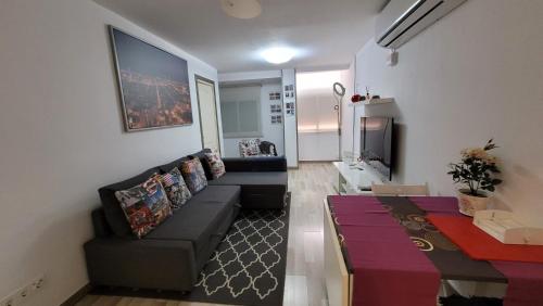 - un salon avec un canapé et une table dans l'établissement APARTAMENTS B O D CoLLBLANC, à L'Hospitalet de Llobregat