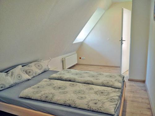 Un pat sau paturi într-o cameră la Peter Horn - Ferienwohnungen unter Reet