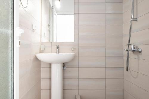 a white bathroom with a sink and a shower at Blue Horizon in Himare