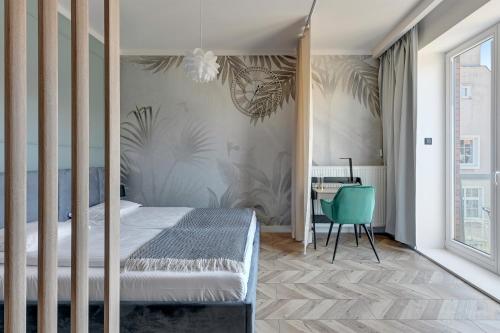 a bedroom with a bed and a desk at Old Town by Welcome Apartment in Gdańsk